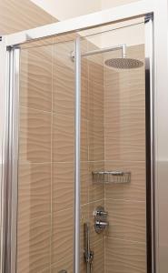 a shower with a glass door in a bathroom at Millefiori in Cagliari