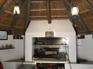 a kitchen with a grill in a room with lights at Seesterkloof in Stilbaai
