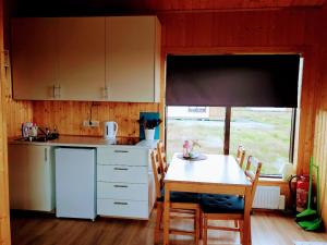 a small kitchen with a table and a table and chairs at Hekla Cabin 3 Volcano and Glacier View in Hella