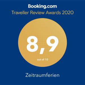 a yellow circle with the number eight and the text travelling review awards at Zeitraumferien in Bernau am Chiemsee