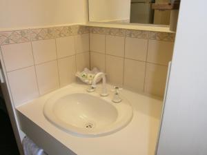 
a white sink in a white bathroom at Kellys Motel Oakey in Oakey
