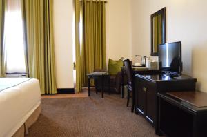 a hotel room with a bed and a desk at Majestic Five Hotel in Palatswe