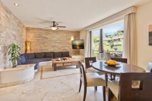 a living room with a couch and a table at El Taj Oceanfront and Beachside Condo Hotel in Playa del Carmen +108 photos