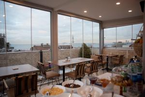a restaurant with tables and chairs and large windows at Blue Mosque Suites 2 - Old City Sultanahmet in Istanbul