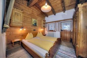 a bedroom with a bed in a wooden room at Ferienhäuser Reither Almen in Reith im Alpbachtal