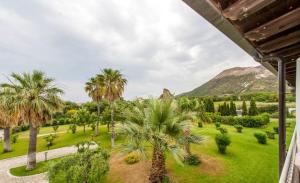 a view of a park with palm trees and a mountain at Hotel Garden in Vulcano
