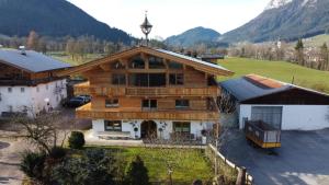 an aerial view of a wooden house with mountains in the background at Bauernhof Bichlhof in Söll