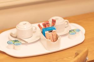 
a tray with a cupcake on it and a toothbrush on it at Station Hotel in Gloucester
