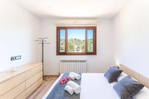 a bedroom with a bed and a window at Sa Tanca de sa Nina in Mancor del Valle +26 photos