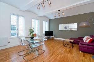 a living room with a glass table and a couch at Mulberry Flat 3 - One bedroom 2nd floor by City Living London in London