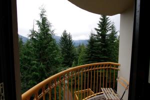 a balcony with a view of trees and mountains at The Marquise by Whistler Premier in Whistler