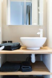 a bathroom counter with a sink and a mirror at Sweet Home Rennes Centre Historique 65 m2 in Rennes +45 photos