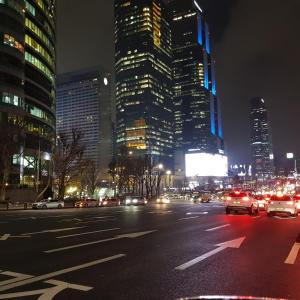 a busy city street at night with cars at Samseong Coexmall S in Seoul