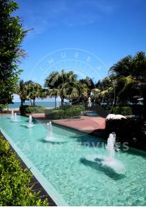 a fountain in a park with a ferris wheel in the background at TimurBay Stunning By CA CON in Kuantan