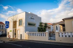 a house with a sign on the side of it at Costa & Isaias Apartamentos in Angra do Heroísmo