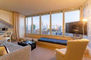 a living room with a couch and a large window at Lx Boutique Hotel in Lisbon