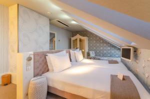 a bedroom with a large white bed in a room at Lx Boutique Hotel in Lisbon