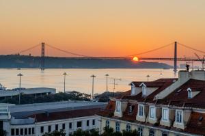 
a city skyline with boats docked at a pier at Lx Boutique Hotel in Lisbon
