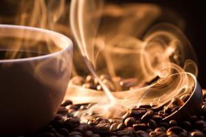 a cup of coffee and coffee beans with smoke at MERLOT SUNSET The BEST Bed and Breakfast in Rideau Lakes in Portland