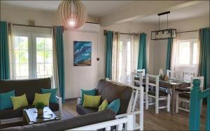 un soggiorno con divano e una sala da pranzo di Palmar Beach Villa a Palmar