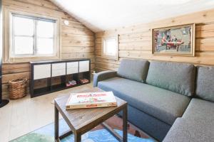 a living room with a couch and a table at Stranda Fjellgrend in Stranda