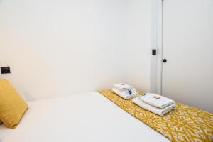 a room with a bed with two towels on a table at CMG Porte Maillot/ Saint-Ferdinand in Paris