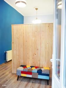 a bed in a room with a wooden wall at My Lovely Home In Budapest in Budapest