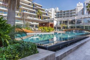 a swimming pool in the middle of a building at Carmencita Studio B14 with pool in Limassol +11 photos