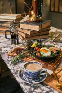a table with a plate of food and a cup of coffee at The Mustang Blu in Bangkok +22 photos
