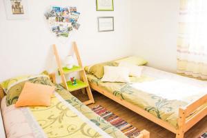 a bedroom with two beds and a table with a lamp at House Divna in Kraj