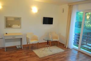 a room with a desk and a table and chairs at Hotel Art Media in Herceg-Novi