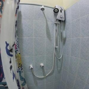 a shower with a hose in a bathroom at Arivilla Beach in Mathiveri