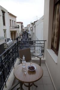 a table with a bowl of fruit on a balcony at Antica Dimora Suites in Rethymno Town