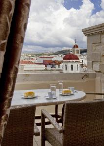 a table with two plates of food on a balcony at Antica Dimora Suites in Rethymno Town
