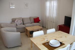a living room with a table and a couch at Apartamento Iris in Córdoba