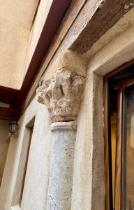 a stone lion head on the side of a building at El Apartamento de la Yaya in Toledo