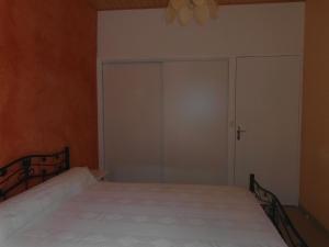 a bedroom with a bed and a sliding glass door at Chalet Bruyère in Cauterets