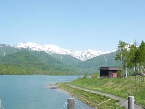 a view of a lake with mountains in the background at Do Sports Plaza Madarao in Iiyama