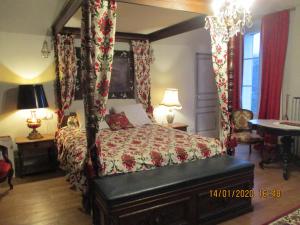 a bedroom with a four poster bed with a canopy at Le domaine de Beaufai in Beaufai