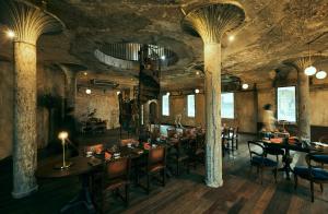 a restaurant with tables and chairs in a room at The Mustang Blu in Bangkok