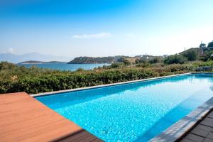 a swimming pool with a view of the water at Mirabella Apartments in Agios Nikolaos