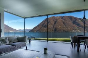 a living room with a view of a mountain at Marvelous Lake Destination eco-friendly villa in Brienno