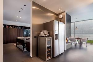 a kitchen and dining room with a refrigerator and a table at Marvelous Lake Destination eco-friendly villa in Brienno