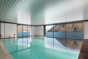 a swimming pool with a view of the water at Marvelous Lake Destination eco-friendly villa in Brienno