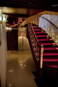 a staircase in a house with a red stair case at Antica Dimora Suites in Rethymno Town