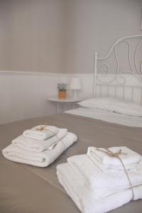 two towels are sitting on the floor next to two beds at Dimora San Domenico in Palermo