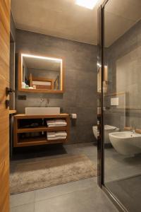 a bathroom with a sink and a mirror at Casa Le Rondini in Valdisotto +73 photos