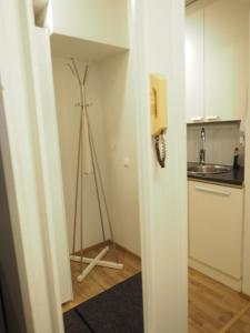 a room with a tripod in the corner of a kitchen at Apartment Oulu station II in Oulu +21 photos