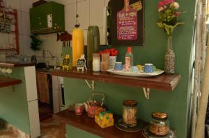 a kitchen with a counter with dishes on it at Hostel MPB Ilha Grande in Abraão