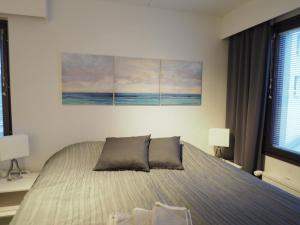 a bedroom with a bed with two pillows on it at Apartment Oulu station II in Oulu